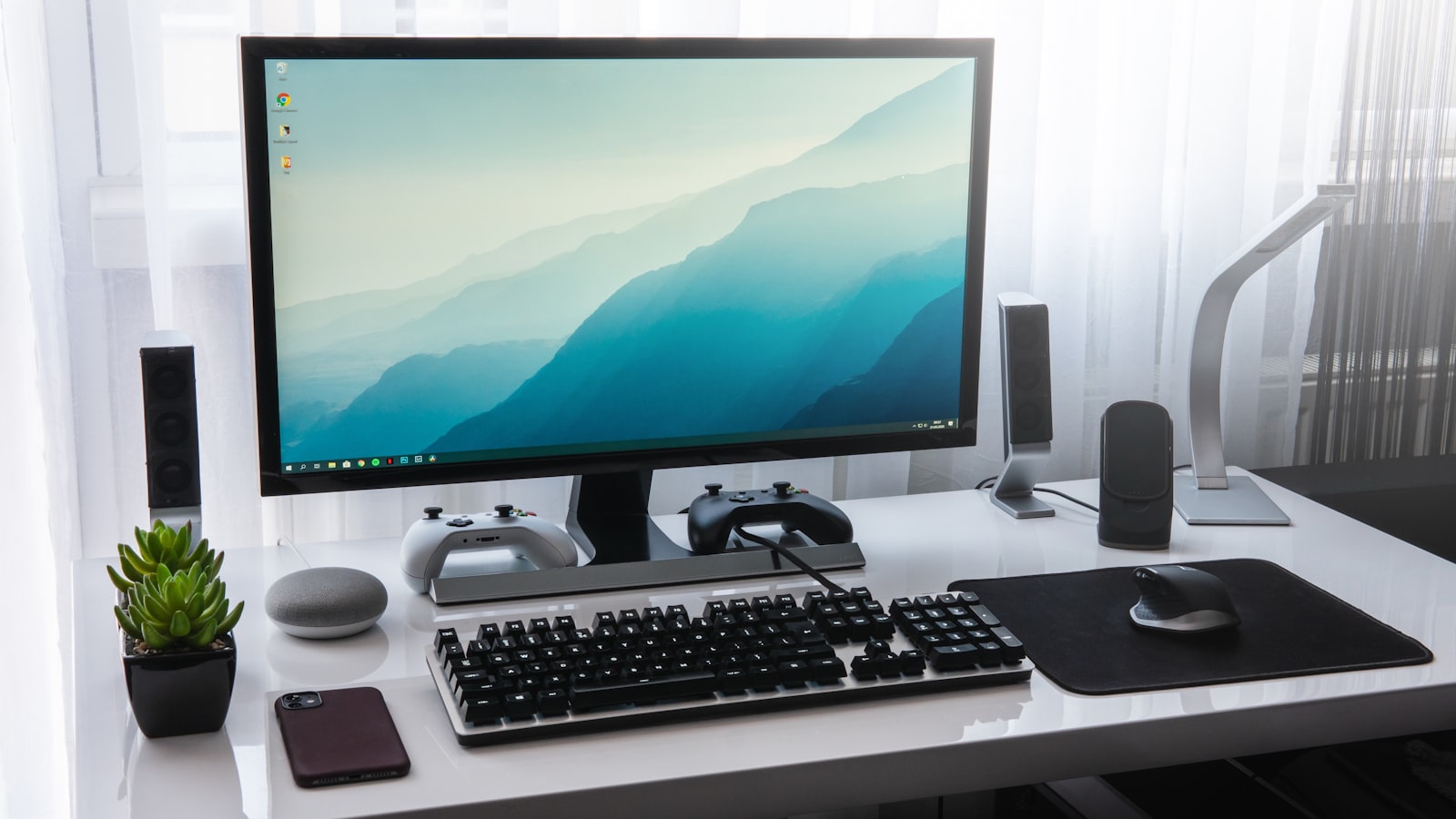 Office workstation with monitor, keyboard, mouse and desktop speakers
