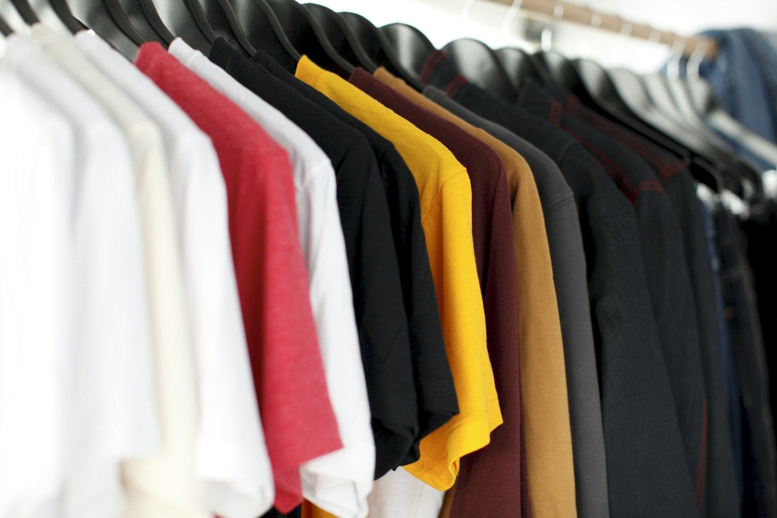 Rail of plain shirts in assorted colours ready for uniform supply