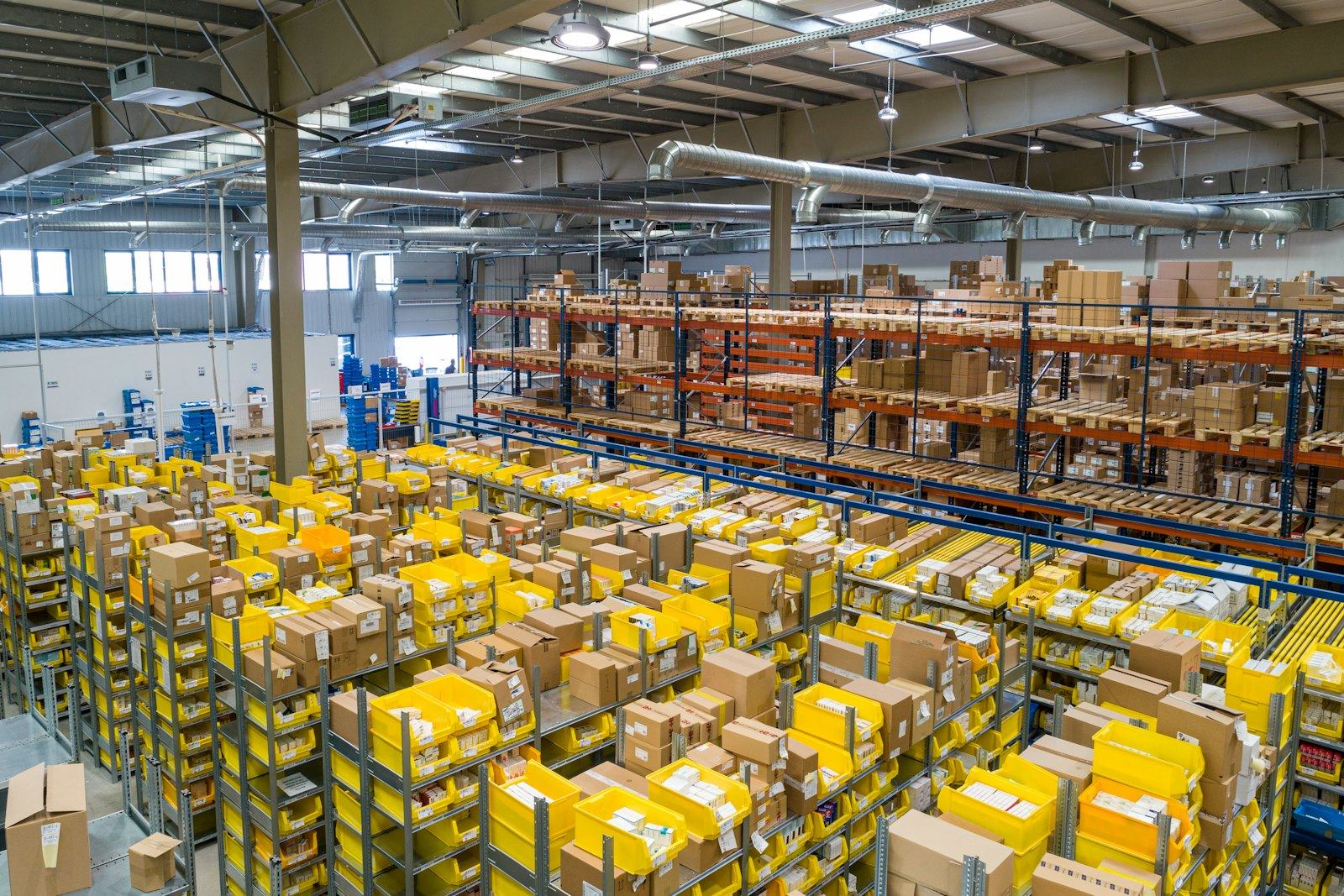 Warehouse racks stocked with office furniture and supplies